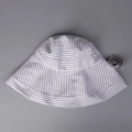Flat lay of striped cotton linen sun hat with detachable gray adjustable chin strap - M (56-58cm) / White