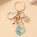 Luminous conch and starfish keychain with blue resin shell charm on gold ring - Blue