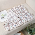 Soft coral fleece pet blanket with white elephant pattern on a textured sofa - Coffee Elephant