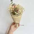 Close-up of mini dried flower bouquet with baby's breath and roses in newspaper wrap - Vintage Mini Leo Rose
