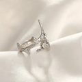 Macro view of hammer textured silver ring with two clear zircons on silk background - Silver Zirconia Ring / Silver