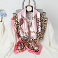 Detail of pink silk scarf with leopard print and golden chain pattern on white shirt - Pink Chain