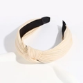 Knotted beige knitted wide headband with cross knot design for women on a white background - Beige