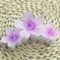 Purple plumeria flower hair claw clip with gradient petals on woven background - Triple Petal Flower [Purple]