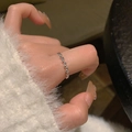 Elegant silver beaded heart ring worn by a model against a blurred textured background - Silver Small Bead Style (J4077)