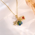 Detailed macro view of gold travel necklace with airplane and passport charms - Gold Airplane Heart Passport Style