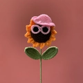 Handmade crochet sunflower plush with pink hat and sunglasses on pink backdrop - Cartoon Sunflower Pink
