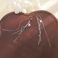 Elegant silver tassel earrings with stars on heart wood tray, refined fringe jewelry style - Wave Star Ear Threader