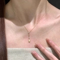 Close-up of a gold water-drop pendant necklace with zircon on a model's neckline - Brushed Matte Water Drop Style (1#)