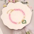 Detailed shot of multi-color heishi bead bracelet with a rhinestone heart charm in a tray - 5# Spotted Pink