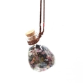 Detail of a glass wishing bottle with colorful crystal stones and a wooden cork stopper - Tourmaline
