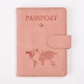 Detail of rose pink RFID passport holder featuring world map embossing and snap button - Pink