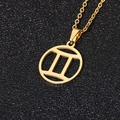 Golden stainless steel Gemini zodiac necklace with a hollow round pendant on black background - Gemini / Gold