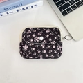 Detailed view of black floral quilted storage bag with zipper and snap-button flap pocket - Black with Pink Floral