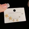 Three pairs of elegant gold snowflake stud earrings with sparkling white crystals - Gold-Snowflake Stud Set (18#)