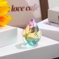 Macro shot of iridescent glass chicken figurine with rainbow finish on white stand - Zodiac Rooster / Rainbow Gradient