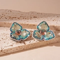Macro shot of silver flower earrings with teal AB crystals and champagne pink studs - Silver Earring Post Style / Blue