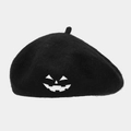 Macro detail of the pumpkin smile embroidery on a black wool beret for Halloween - M (56-58cm) / Black with White Embroidery