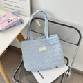 Detail of blue and white checkered quilted tote bag with Sezakka Studio brand label - Light Blue Plaid