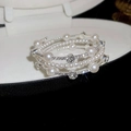 Macro shot of multi-layer pearl bracelet with sparkling crystals in white jewelry box - Silver Multi-layer Pearl Rhinestone Style
