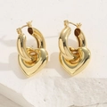 Minimalist golden heart shaped hoop earrings displayed on white textured stone background - Gold Hollow Out