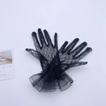 Close-up of elegant black floral lace gloves with double-layered ruffled cuffs and vintage style - Black Mesh Gloves