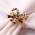 Macro detail of Christmas candy cane napkin ring with red bow and metallic finish - Candy Cane