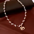 Elegant gold plated pearl necklace featuring a vintage rocking horse pendant on silk backdrop - Gold Pony Style (Real Gold Plated)