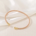 Detail of hand-woven pink and gold silk thread bracelet with metallic spherical ends - Pink