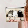 Large capacity canvas pencil case held by hand featuring three cartoon cats illustration - Cartoon Three Cats Style