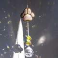 Close-up of crystal paw print prism and glass ball reflecting vibrant rainbow light spots - Round Crystal Ball Style / Gold