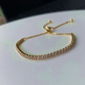 Macro shot of adjustable gold tennis bracelet with brilliant cubic zirconia slider - 1.8mm Zirconia / Gold