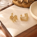Detail of 18K gold-plated beaded heart earrings on linen mat with soft lighting - Heart Beaded Design (ZHE481金)