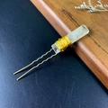 Close-up of handmade golden wire-wrapped yellow crystal quartz on a U-shaped hairpin - Citrine