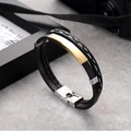 Close-up of a multi-layer black leather bracelet with a gold-plated stainless steel bar - Gold Metal Tag