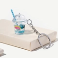 Portachiavi tazza di tè alla frutta luminosa con liquido blu e decorazione a fetta di limone - Blu