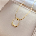 Detailed close-up of square opal pendant on a gold titanium steel necklace in a jewelry box - Gold Square Cat's Eye Stone Style (P217金)