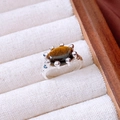 Macro view of vintage 18K gold plated ring with oval tiger eye stone and blue zircons - Silver Tiger Eye