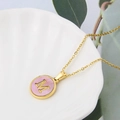 Gold stainless steel letter M necklace with pink shell inlay on a white dish - Pink-M