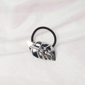 Detail of a black elastic hair tie with a shiny silver metal leaf charm on textured fabric - Leaf Shape (5) / Silver