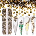 Detailed view of gold multi-faceted rhinestones in 12-grid box with nail art application - SS4-SS12-3600Pcs/Box / Bright Gold