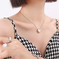 Minimalist silver heart pendant necklace with sleek thin chain on model - Silver Color Small Heart Necklace