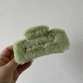 Close-up of green plush rectangular hair claw clip with soft faux fur texture for women - Green