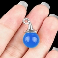 Blue quartz crystal wizard hat pendant accessory with silver top held by hand - Blue Agate