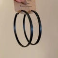 Detail view of large black vintage leopard print hoop earrings held against a plain wall - S925 Silver Pin / 7cm / Black