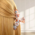 Detailed close-up of a blue and orange marbled resin hair claw clip in blonde hair - Style B Arch (Orange-Blue Marble)