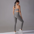 Detail of grey yoga set featuring backless cross-strap bra and high-waisted leggings - Titanium Gray