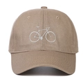 Close-up of embroidered white bicycle design on a khaki cotton twill baseball cap - Khaki