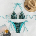 Flat lay of teal leopard print bikini set with straw hat and sunglasses on marble background - Blue Black Leopard