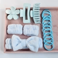 Close-up of light blue hair accessory set featuring velvet bow headband and matte hair clips - Blue (16-Piece Set)